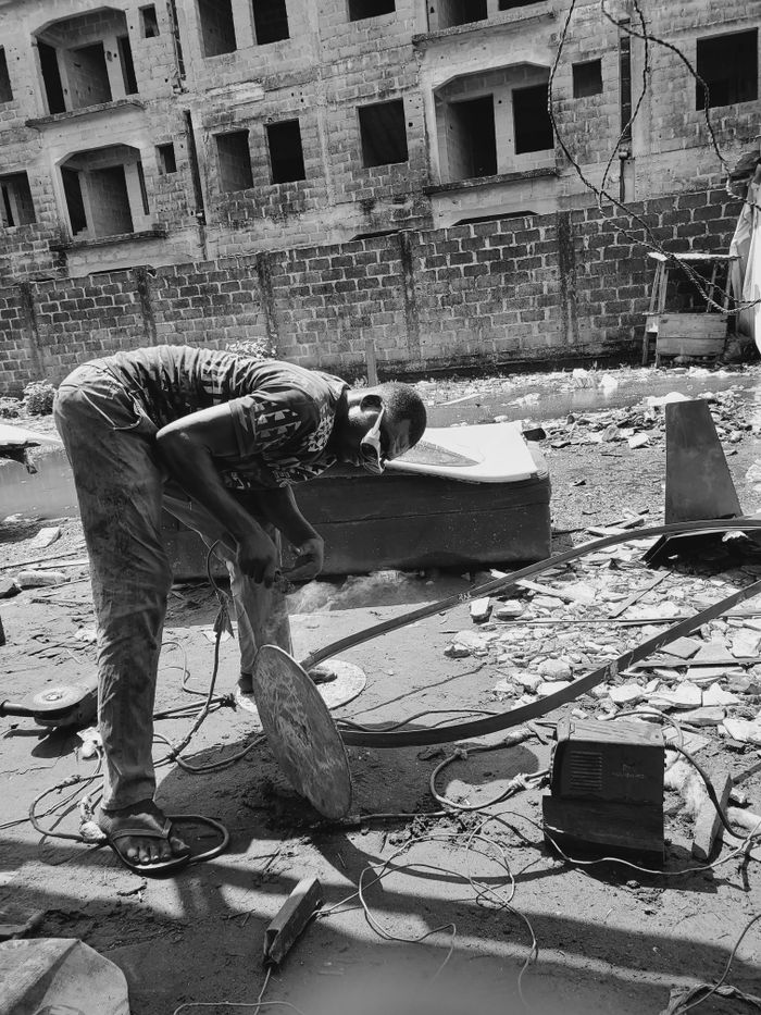 Monochrome image of a man working in a construction site in Lekki, Nigeria.